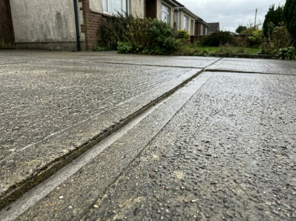 Clean pristine concrete driveway after professional pressure washing